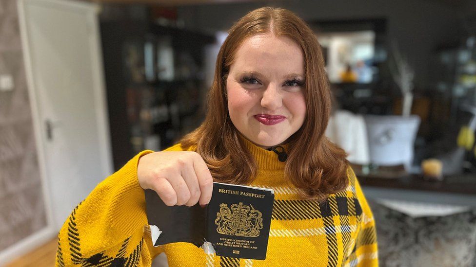 Ellis McLeod holding her chewed up passport