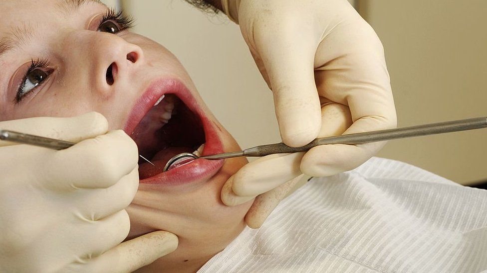 A boy receives dental treatment