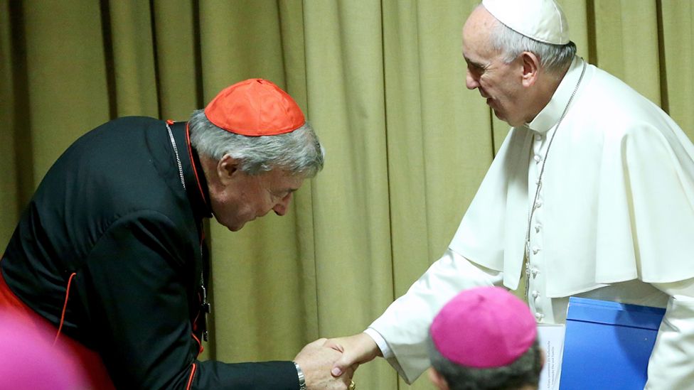 Pope Francis greets Australian Cardinal George Pell as he arrives at the Synod Hall on 20 October 2015 in Vatican City, Vatican