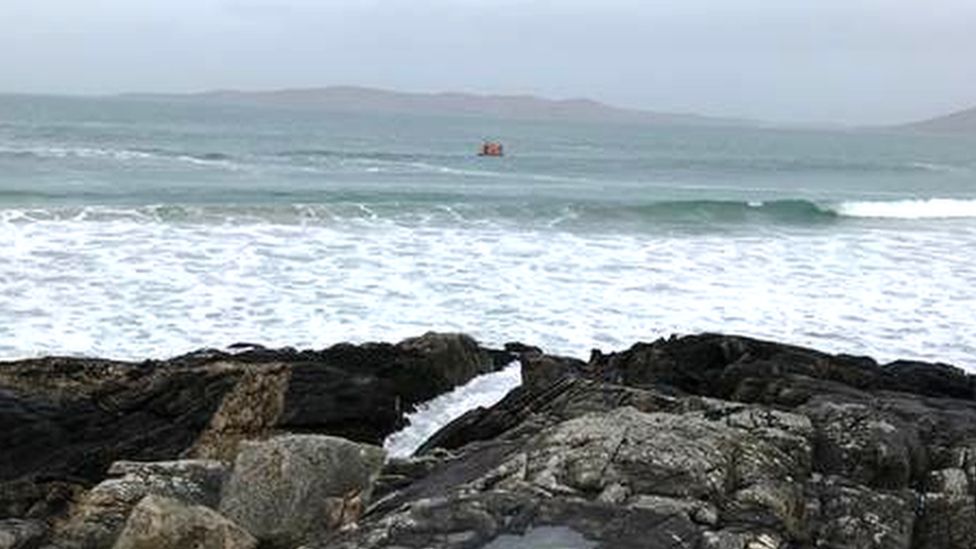 Woman swept into sea