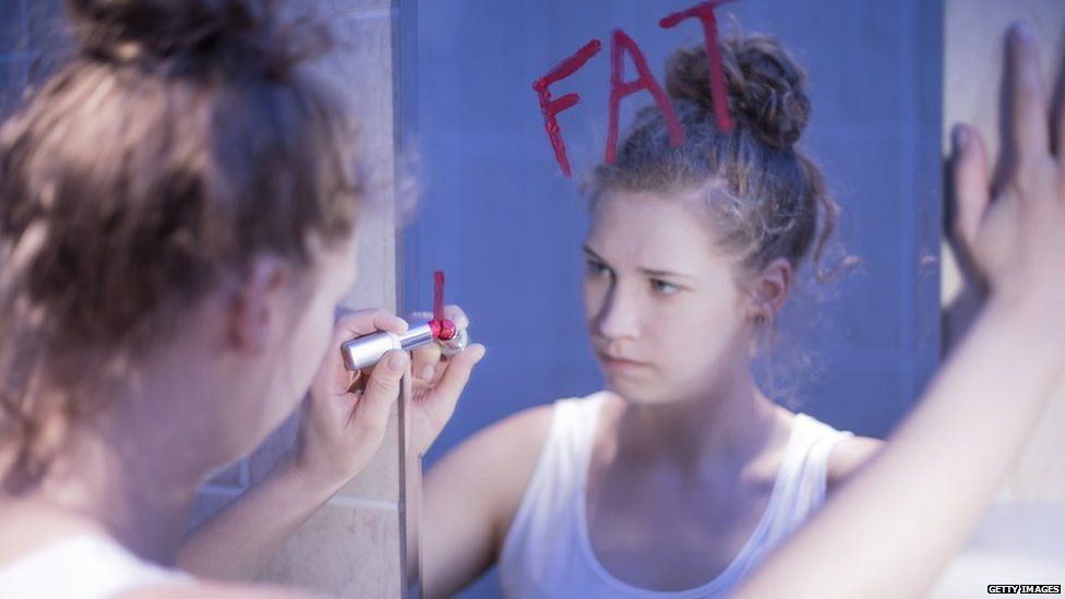 Girl writing on a mirror