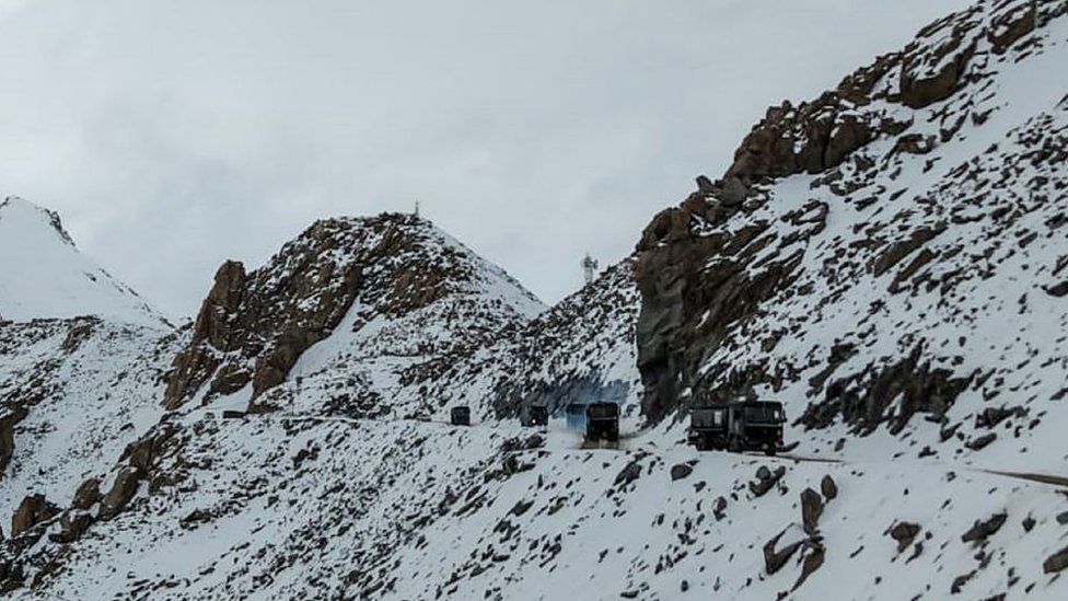 Indian Army vehicles drive on a road near Chang La high mountain pass in northern India's Ladakh region of Jammu and Kashmir state near the border with China on June 17, 2020.