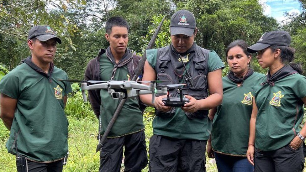 Members of La Guardia, the indigenous guard, use a drone