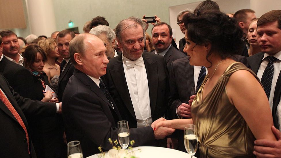 Russian President Vladimir Putin shakes hands with Anna Netrebko