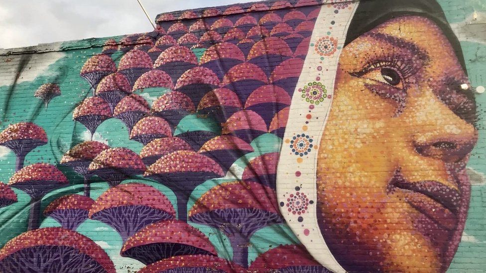 A mural showing a woman wearing hijab in Hamtramck