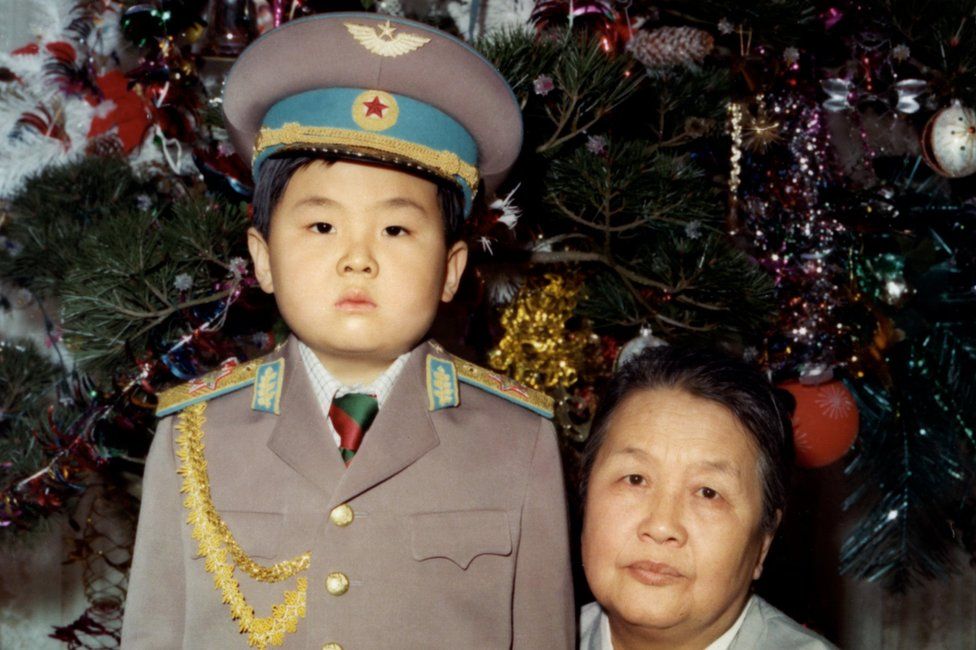 Kim Jong-nam dressed in an army uniform poses with his maternal grandmother in January 1975 in an unknown place