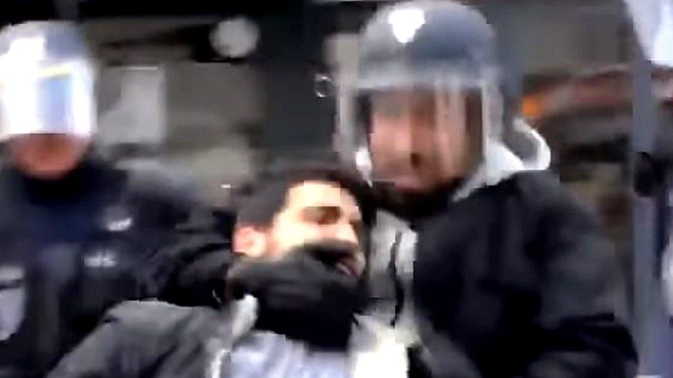 A mobile phone grab shows a man identified as Alexandre Benalla dragging away a demonstrator on 1 May 2018
