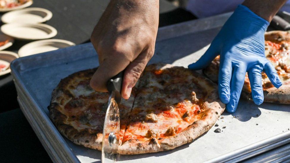 pizza being cut