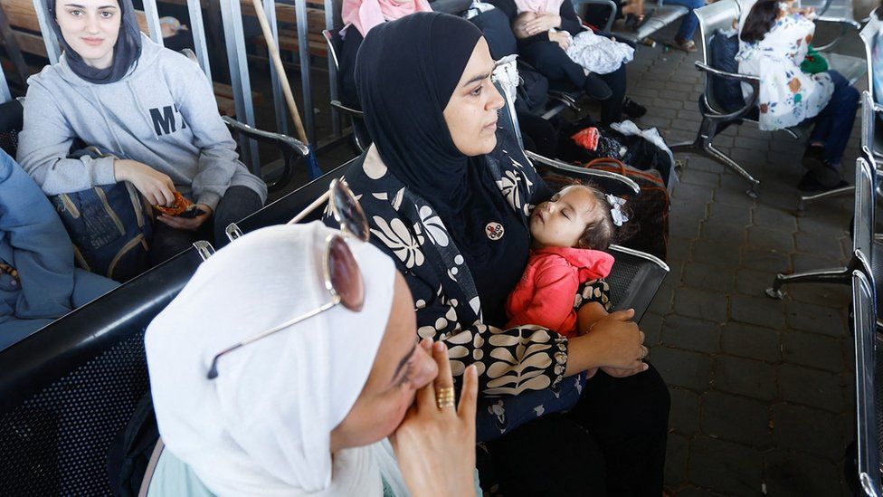 Women and children with foreign passports wait to cross into Egypt from Gaza at the Rafah border crossing (1 November 2023)