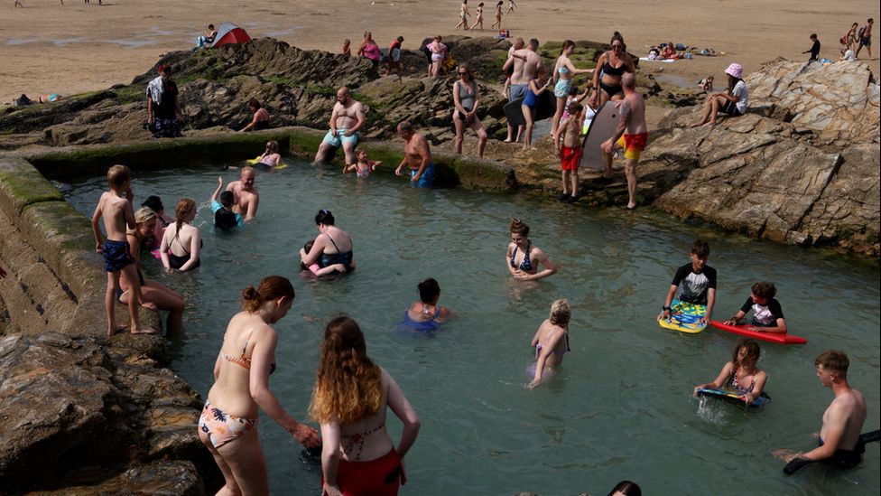 People in a pool at the beach in Perranporth, Cornwall