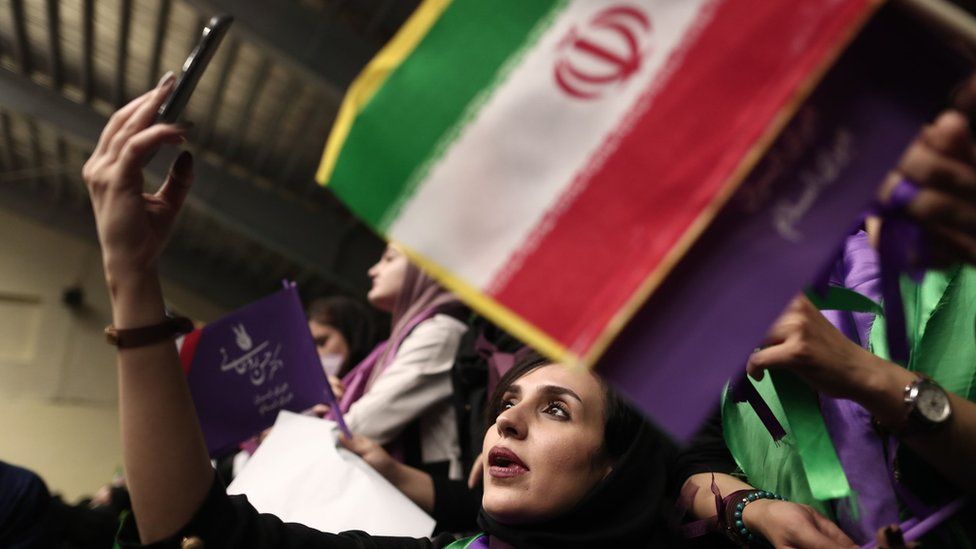 An Iranian woman uses her mobile phone at a campaign rally for Hassan Rouhani in Ardabil (17 May 2017)