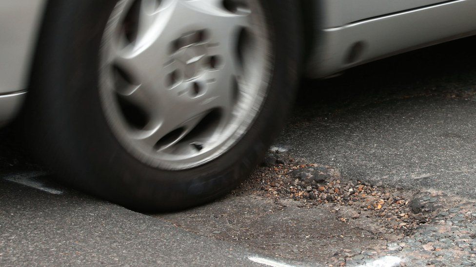 A car going over a pothole