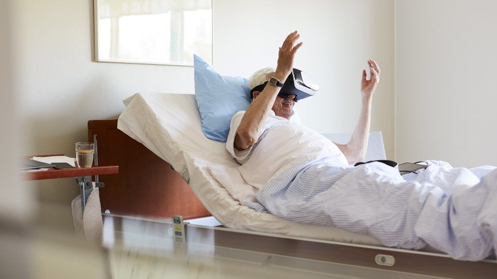 Man in hospital bed with VR headset
