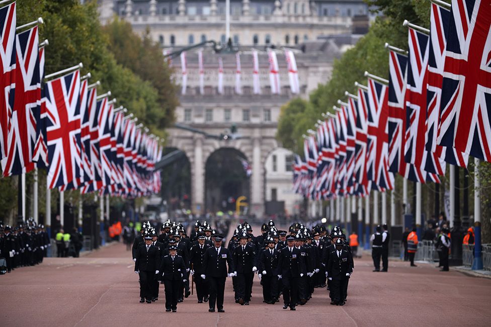 Metropolitan Police Officers are seen walking in formation down The Mall ahead of the State Funeral Of Queen Elizabeth II on 19 September 2022 in London