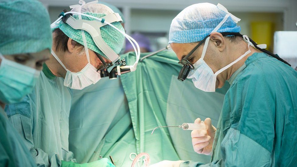 Heart surgeons during a heart operation