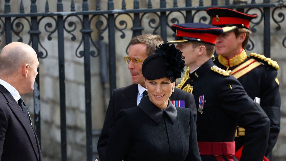 Zara and Mike Tindall walk outside Westminster Abbey after a service