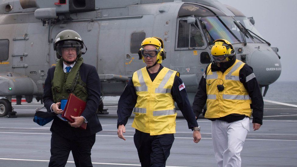 Sir Michael Fallon getting off a helicopter