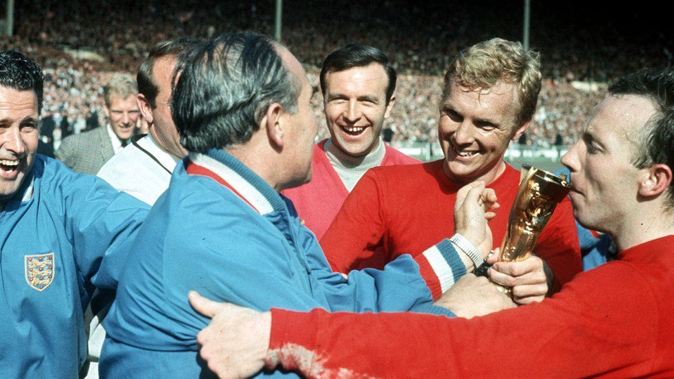 Alf Ramsey, Bobby Moore, Nobby Stiles and others celebrate after England are presented with the trophy