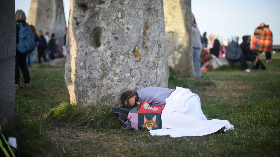 Woman sleeping near Stonehenge
