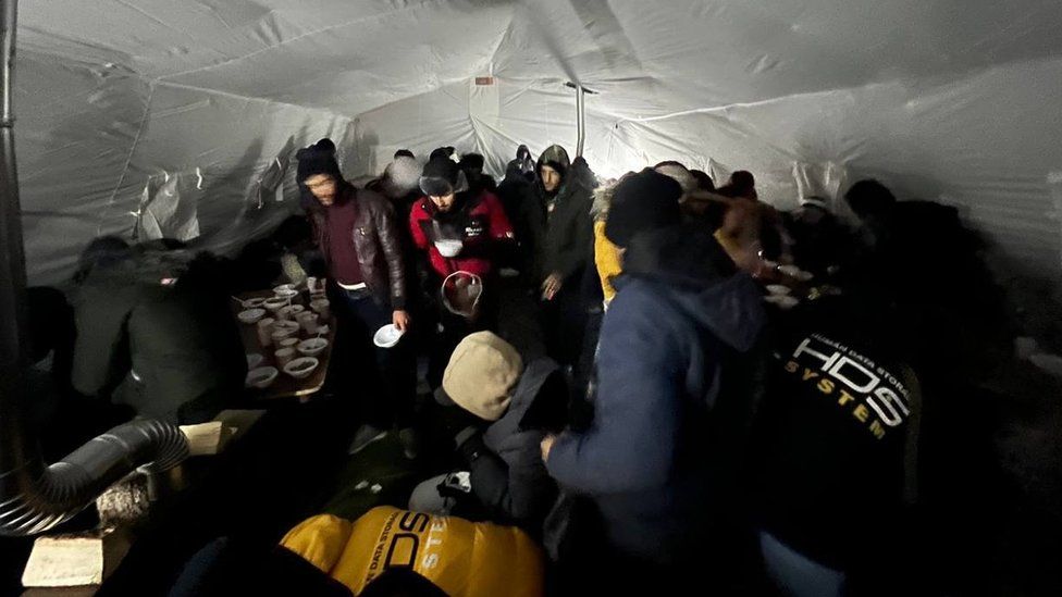 Migrants in a tent on the Russian side of the Salla crossing