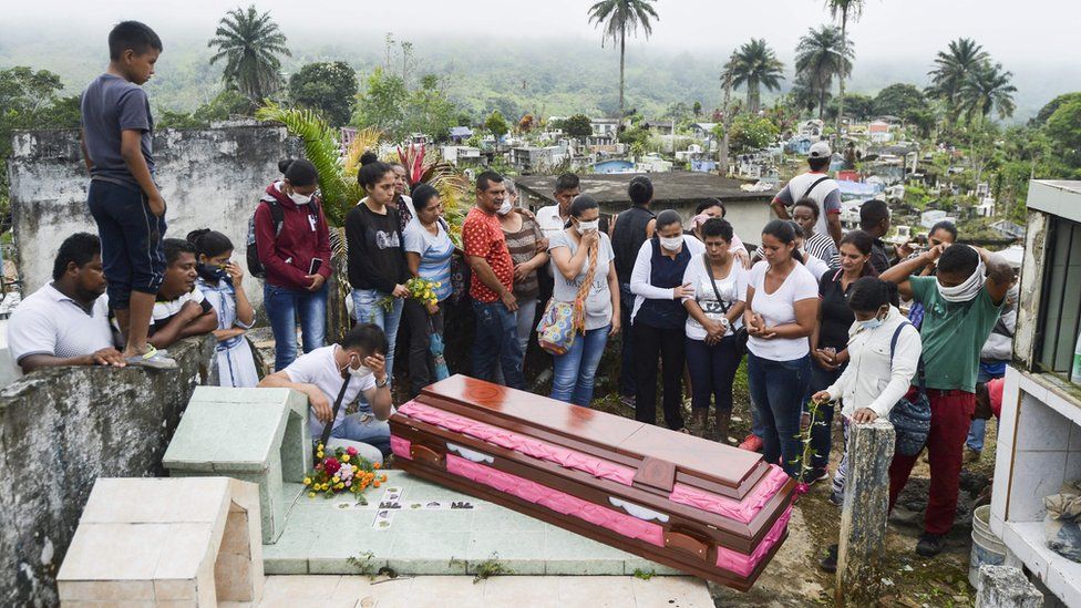 Relatives and friends of Deisy Rosero, 26, pray during her funeral at a cemetery in Mocoa, Putumayo department, southern Colombia