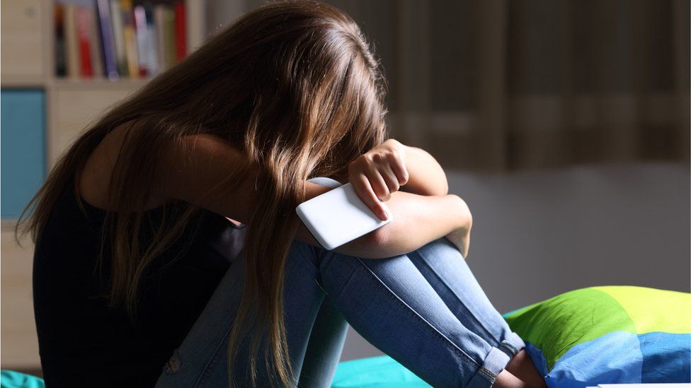 A teenage girl with a smartphone