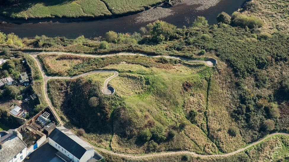 Aerial view of hill with paths and fortification remains