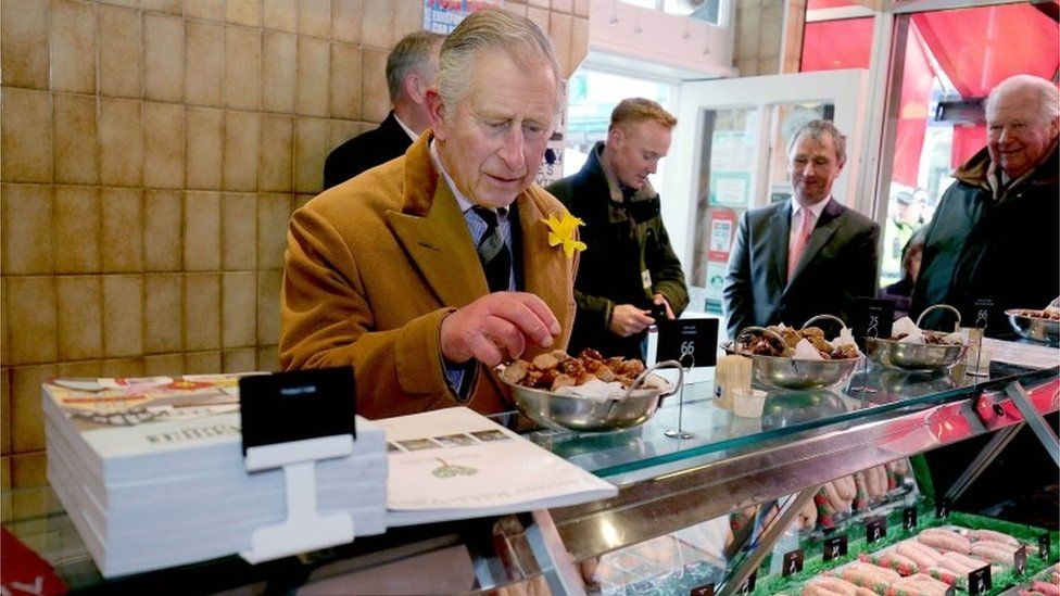 The Prince of Wales looks at products in Cowmans Famous Sausage Shop