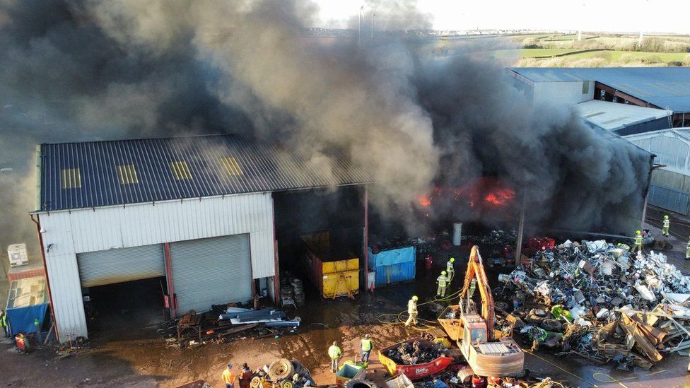 The blaze, in Waterston, Milford Haven, is about 25m x 50m (80ft x160ft) big, say fire crews
