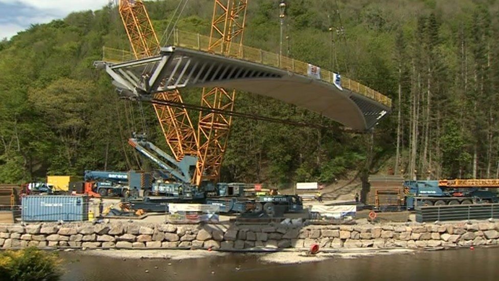 The bridge being lifted into place