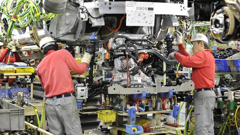 Nissan workers install engine into electric vehicle in 2011