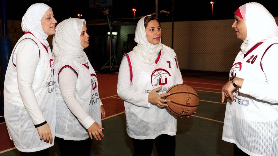 Saudi Lina al-Maaina (centre), coach and founder of the first Saudi female basketball team Jeddah United