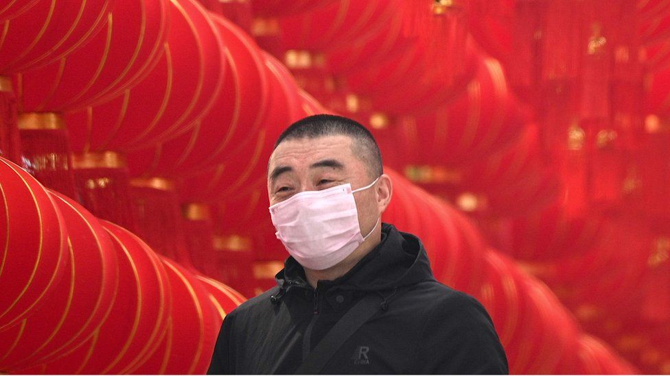 A man in China wearing a mask