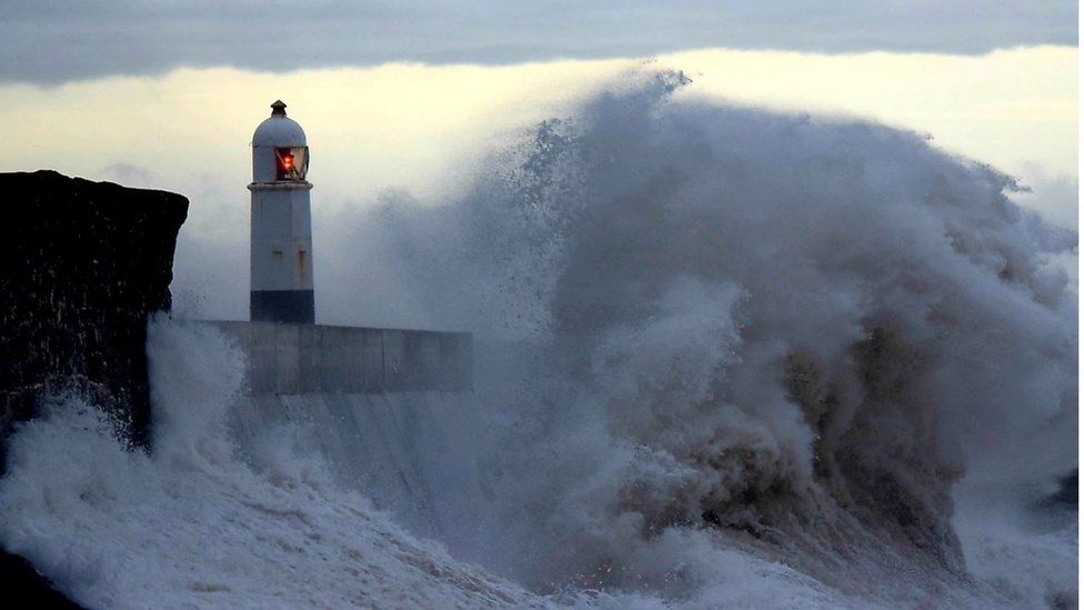 Porthcawl lighthouse was seen surrounded by large waves during Storm Ciara