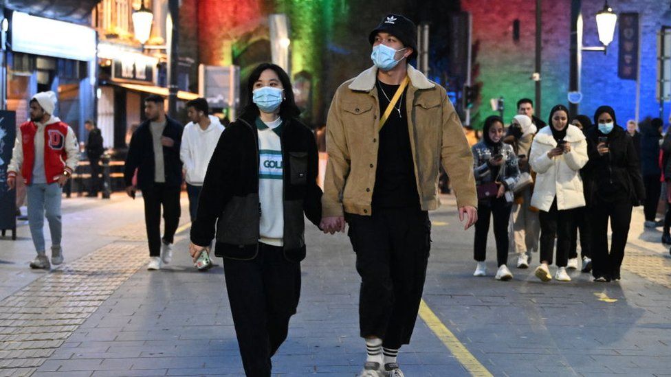 Two people walk down High Street wearing face masks in Cardiff