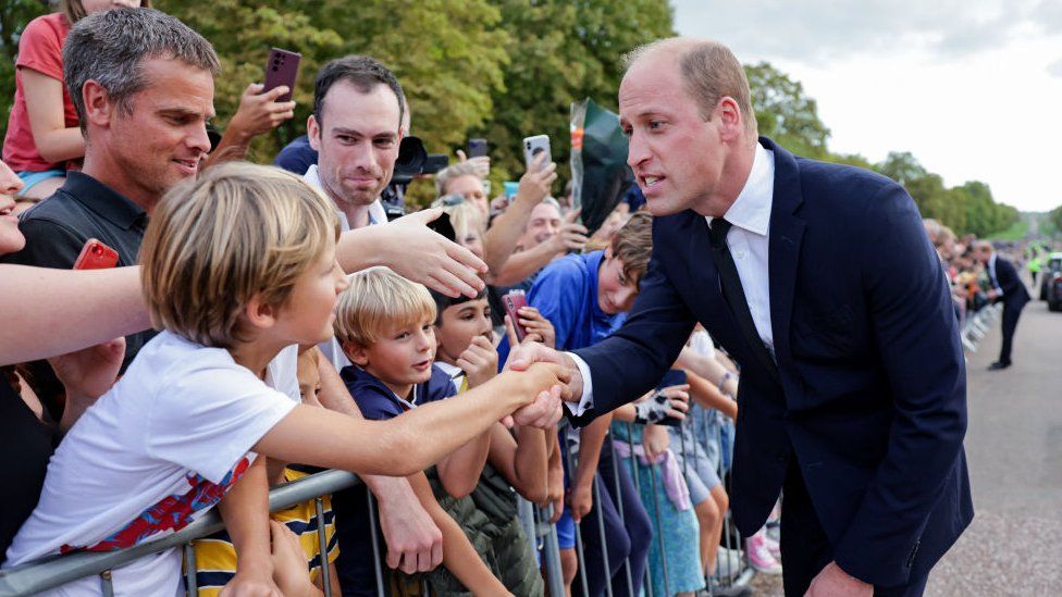 Prince William, Prince of Wales shakes hands with members of the public on the Long walk at Windsor Castle