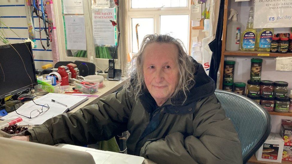 Timothy Carr sitting behind his desk at New Hope Reptile Rehome shop in Cinderford
