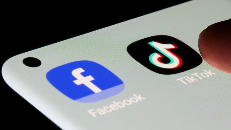 TikTok and Facebook apps on smartphone screen