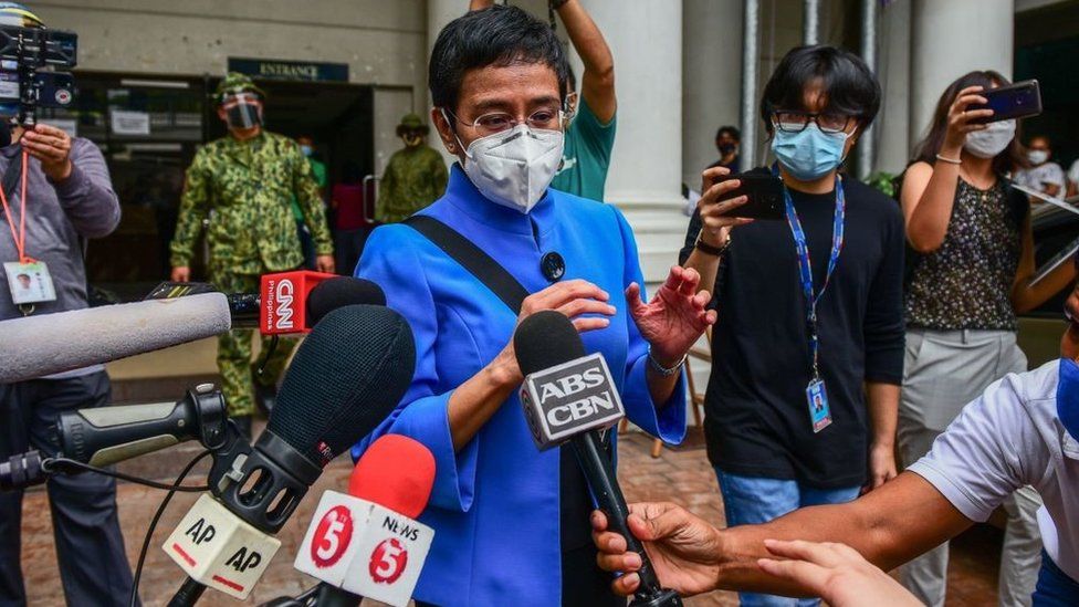 Maria Ressa talks to members of the media after attending a court hearing in Manila on July 22, 2020, on charges of tax evasion