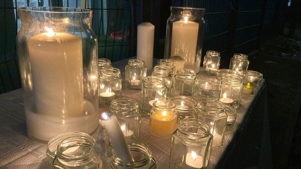 Candles on a table lit for a vigil