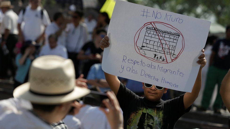 A demonstrator holds a placard reading: "No wall. Respect to immigrants and human rights" during a protest against U.S. President Donald Trump's proposed border wall and to call for unity, in Monterrey, Mexico, on 12 February