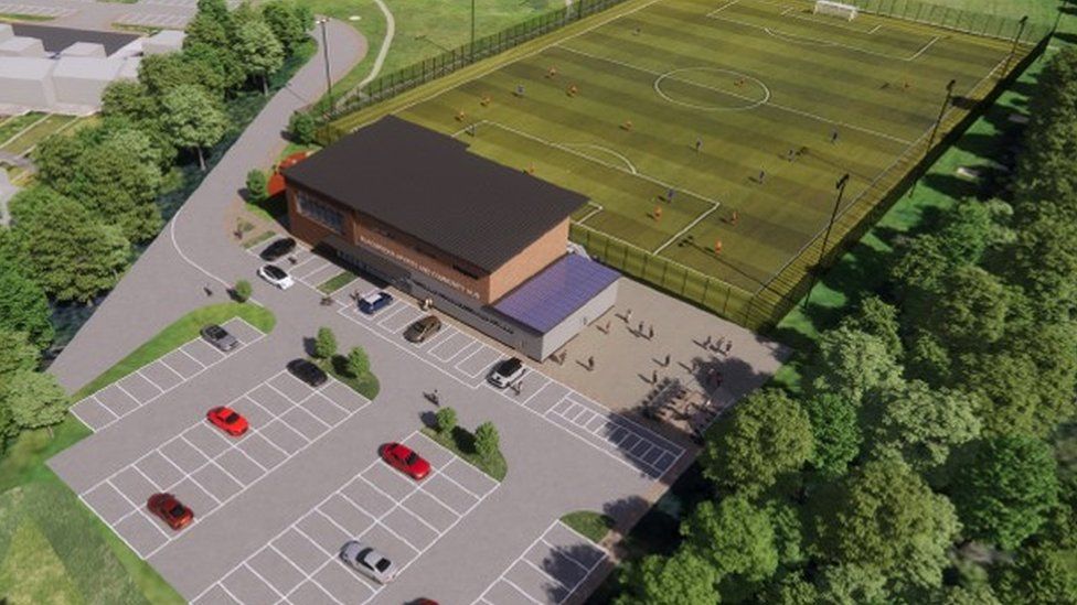 aerial view of the proposed plans - a car park, building and a football pitch