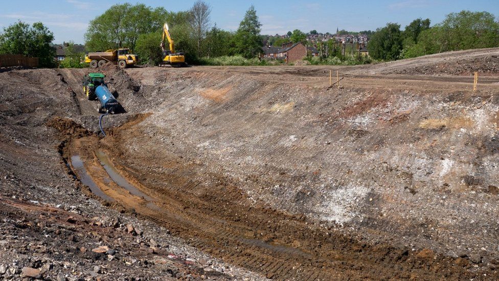 Diggers moving earth at the site