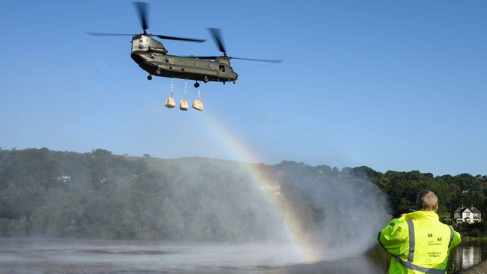 Helicopter creates rainbow in spray