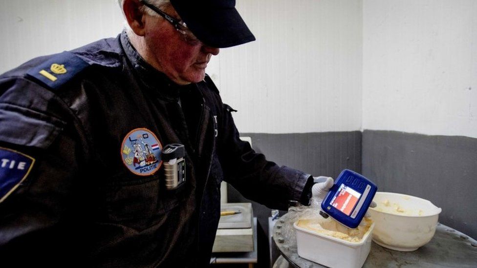 A police officer in the Netherlands examines amphetamines