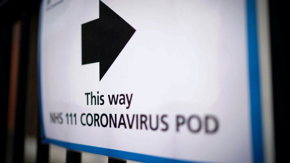 Signs directing people to coronavirus isolation pods