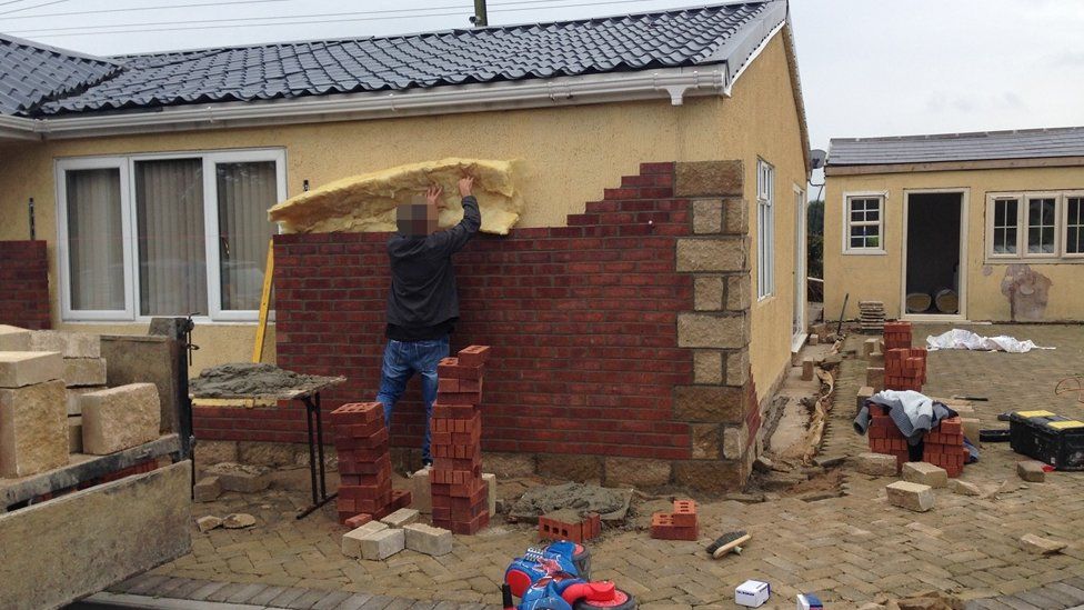Man working on a wall