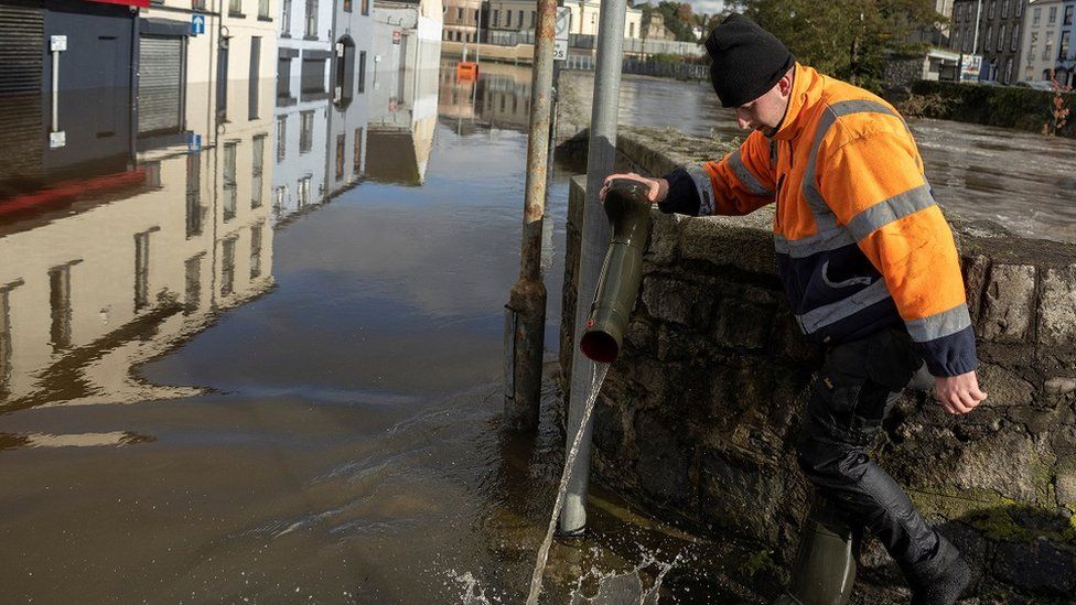 Man empties floodwater out of his boot in Newry