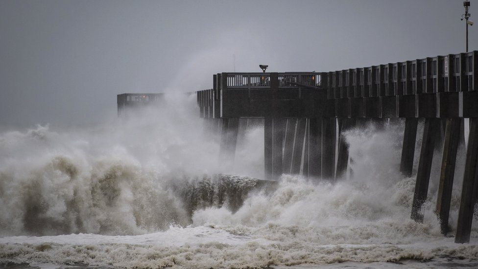 Waves crash against a pier in Miller County as Hurricane Michael approached the Florida Panhandle, 10 October 2018