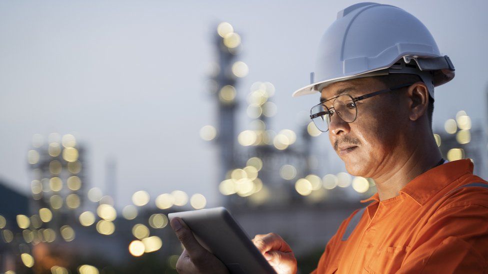 Oil worker looking at a tablet